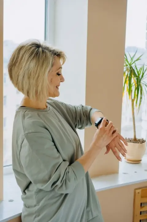 Woman checking her watch between sets